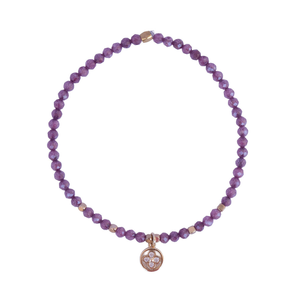 Pulsera de circonita morada con charm de flor dorado