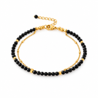Pulsera MAHIRI de espinela negra facetada con detalles dorados y cadena de acero inoxidable