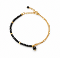 Pulsera RHEA de espinela negra facetada y acero inoxidable dorado